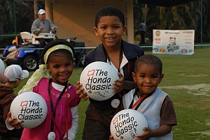 Three Kids Smiling And Holding A Ball